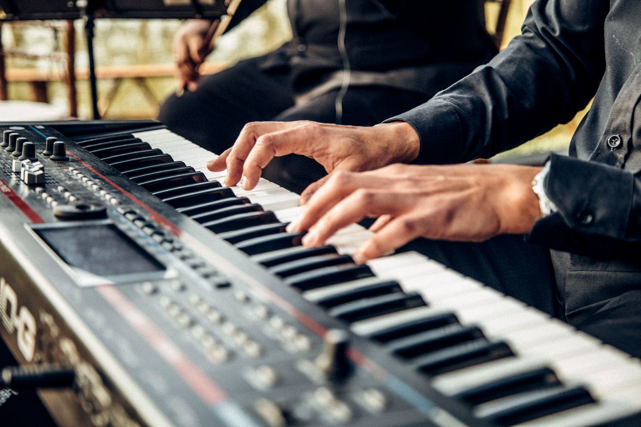The Art of Drawing Readers In: Your attractive post title goes here Hands playing a digital keyboard instrument indoors with selective focus.