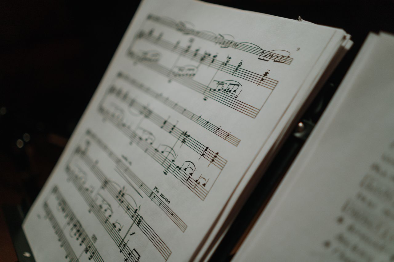 Close-up of sheet music displaying musical notes on a stand, perfect for musical compositions and practice.